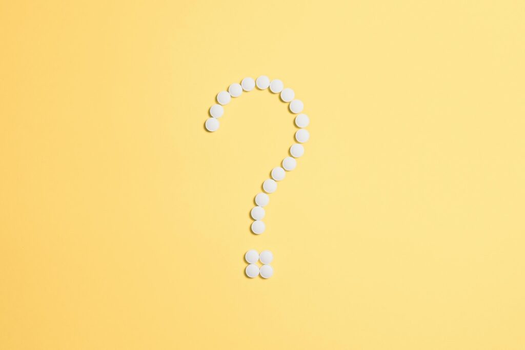 Question mark in white pills on yellow background