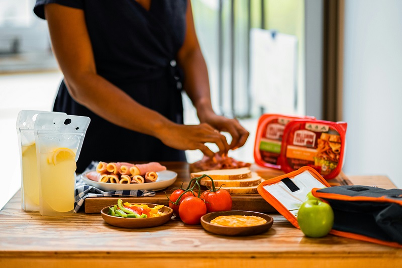 a person setting up food on the table