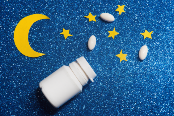 A pill box, stars, and moon on a blue background