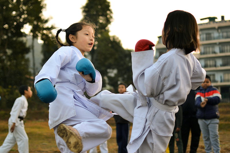 Two children in Karate outfit, fighting with each other