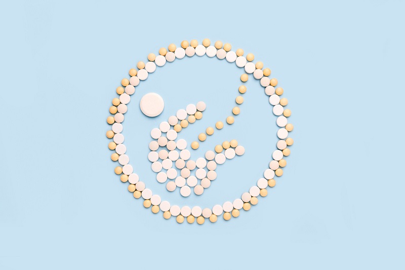 The shape of a baby in a womb is made out of various pills.