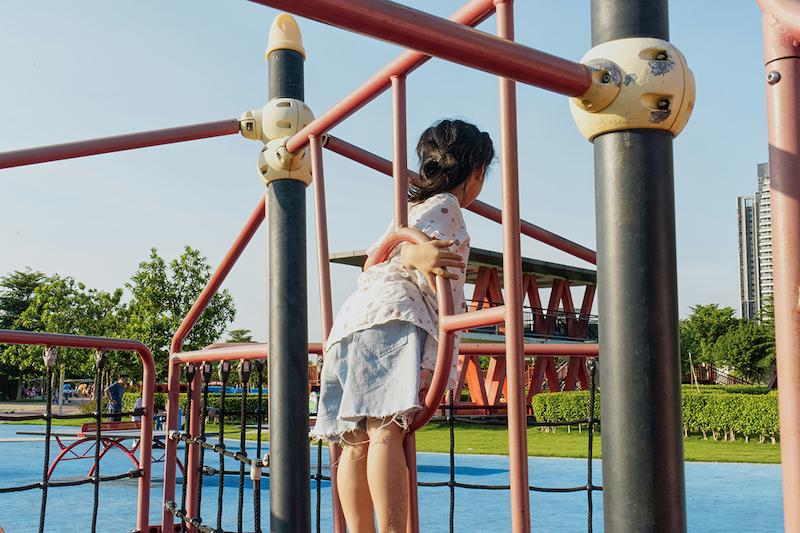 A child climbing a playground ladder