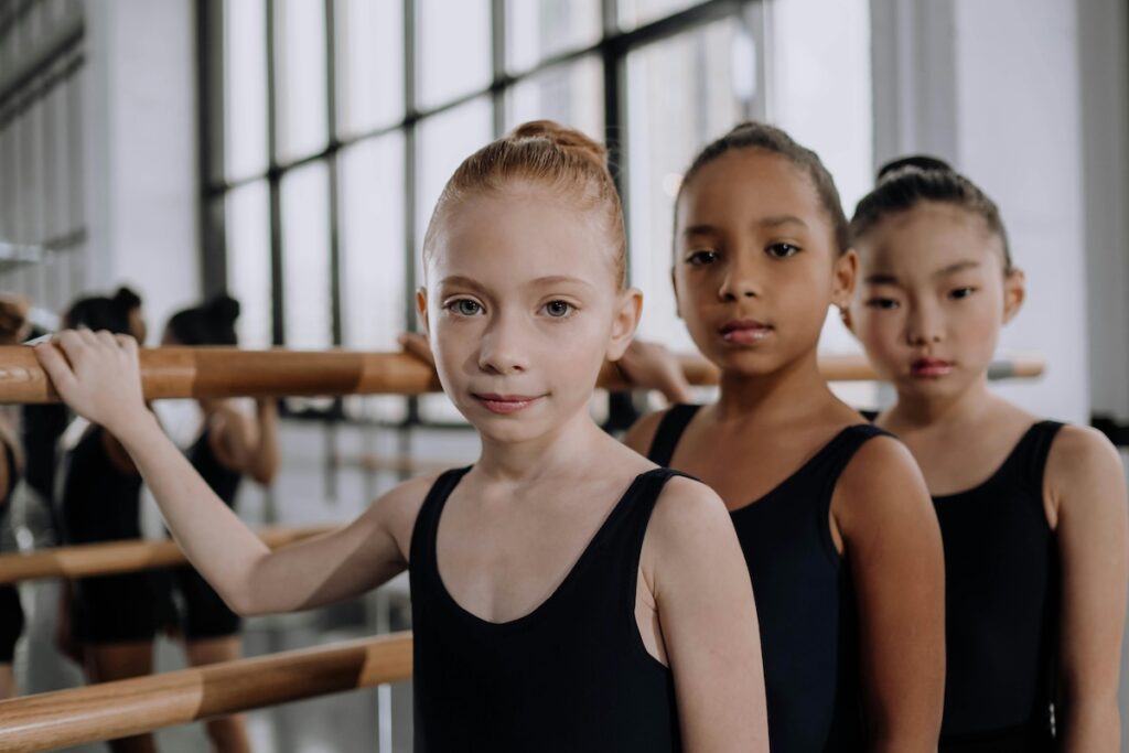 three big kids line up for a gymnastic session