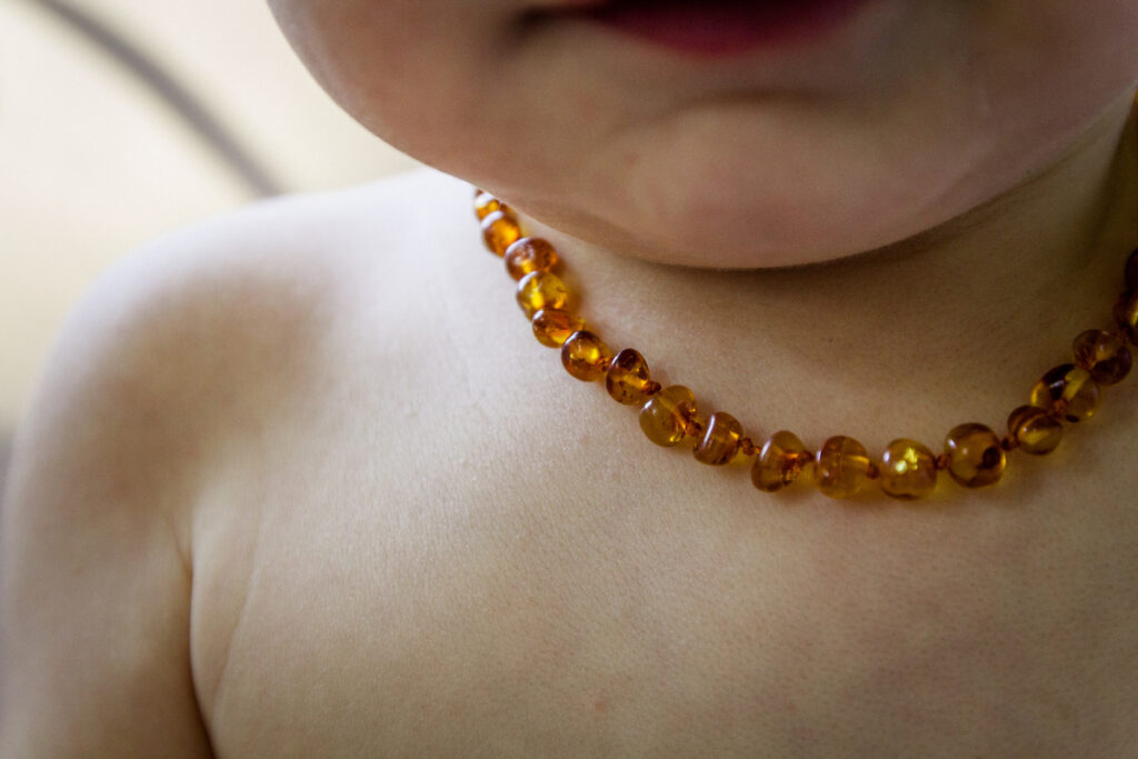 Baby wearing an amber necklace.
