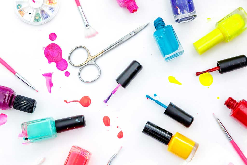 Nail polish and manicure tools spread across a white background.