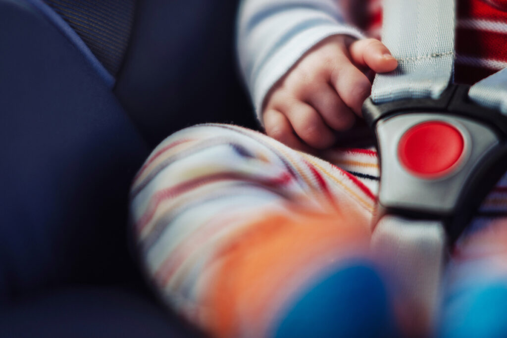 A close-up of a baby in a car seat.