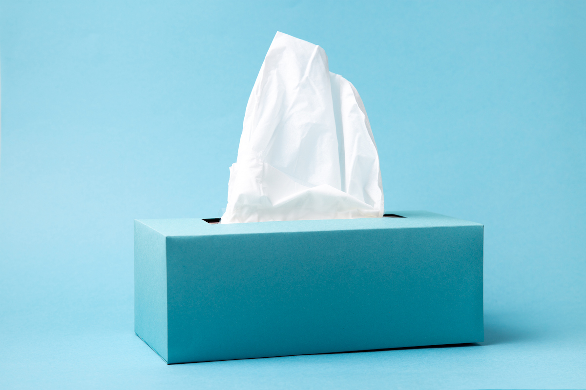 A blue box of tissue on a light blue background.
