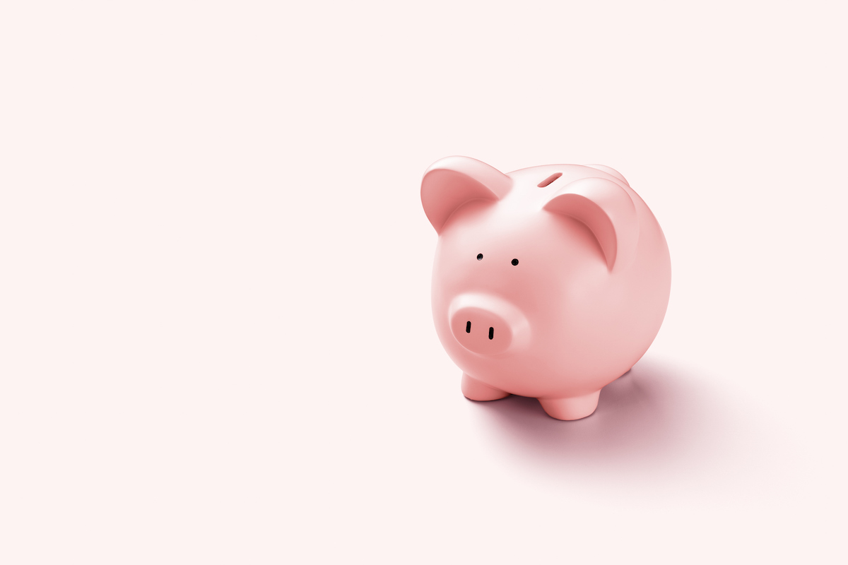 A pink piggy bank on a pink background.