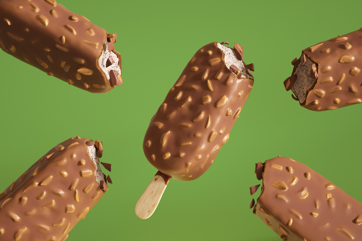 Chocolate covered ice cream popsicles are arranged on a green background.