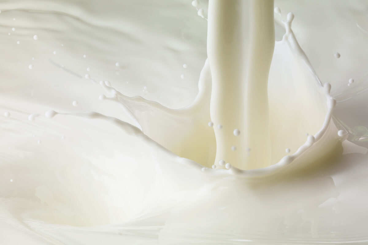 Close-up of milk being poured and splashing.