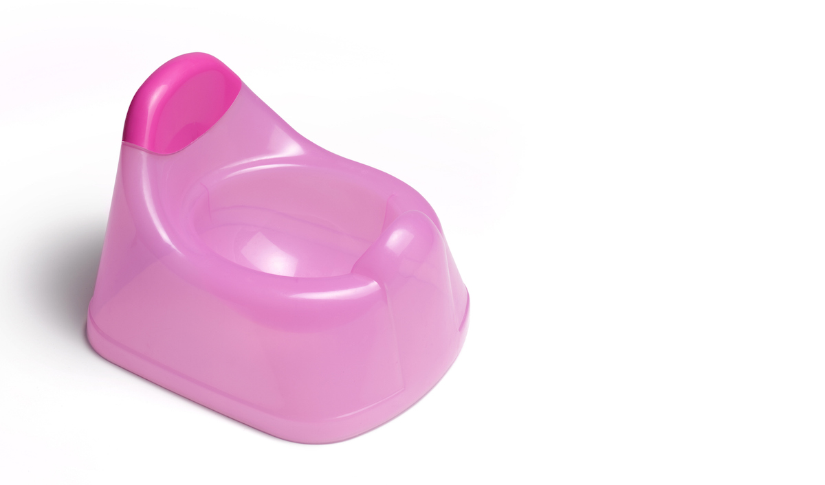 A pink training potty on a white background.