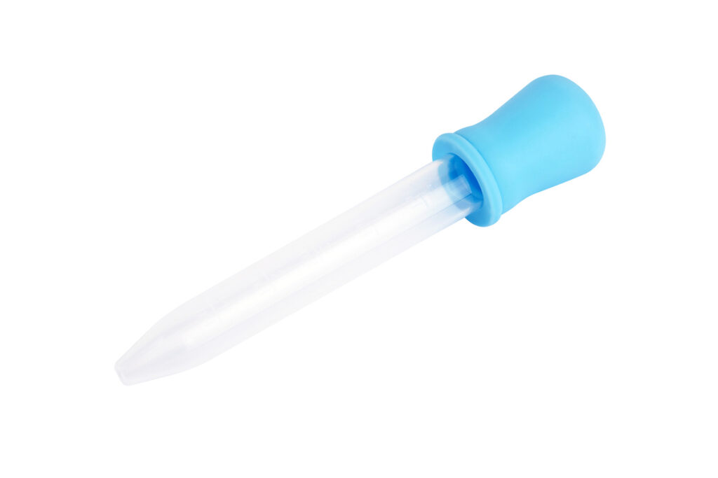 A plastic dropper with a bright blue bulb on a white background.
