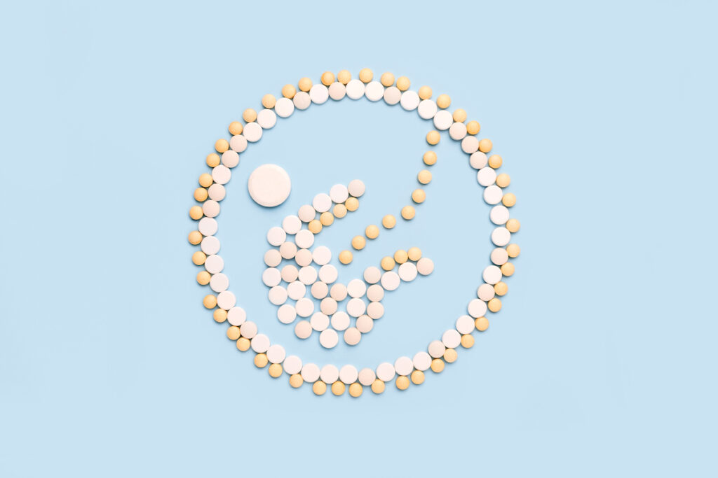 The shape of a baby in a womb is made out of various pills.