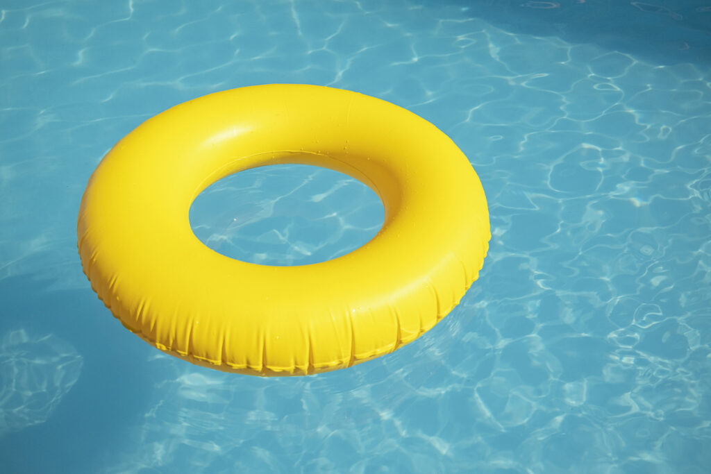 A yellow inner-tube floats in a blue pool.