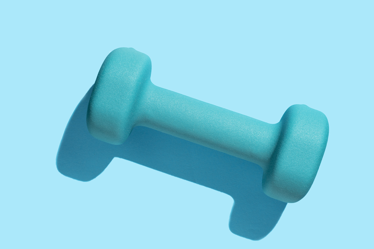 A teal weight is seen on a light blue background.
