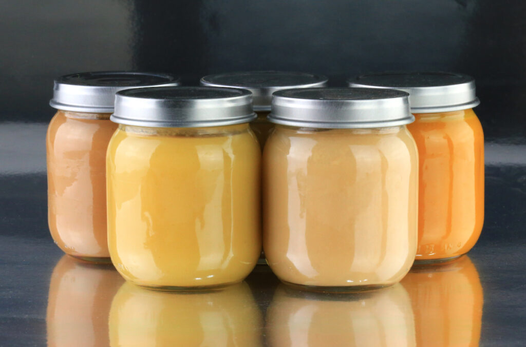 A close-up of pureed baby food in jars.