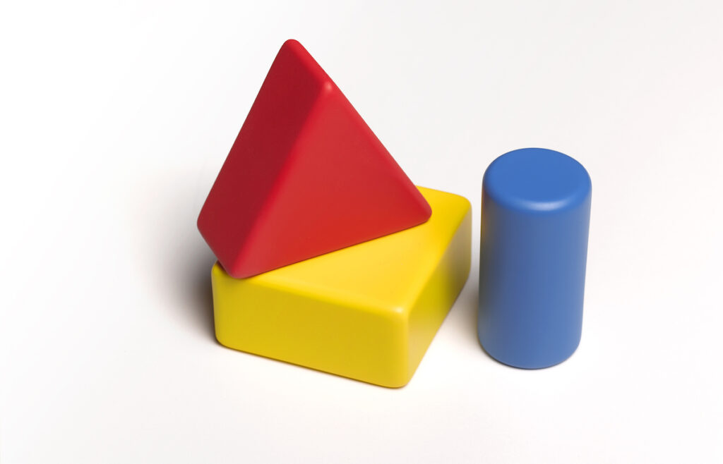 Yellow, red, and blue building blocks on a white background.