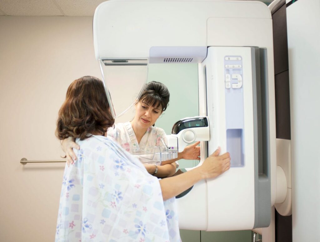 A woman has a mammogram procedure in a doctor's office.