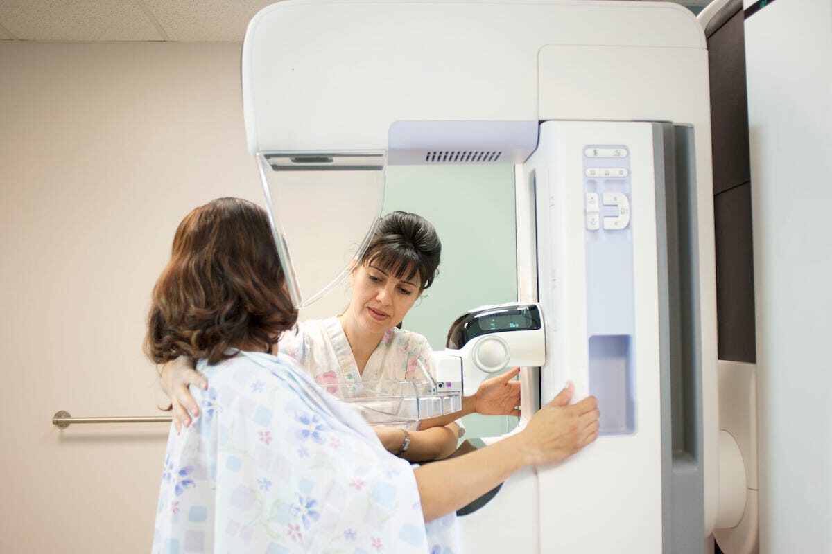 A woman has a mammogram procedure in a doctor's office.