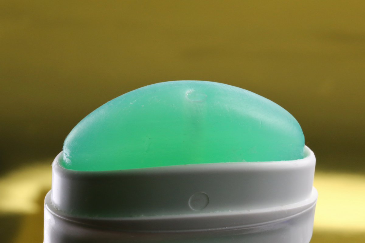 Green deodorant is seen close-up.