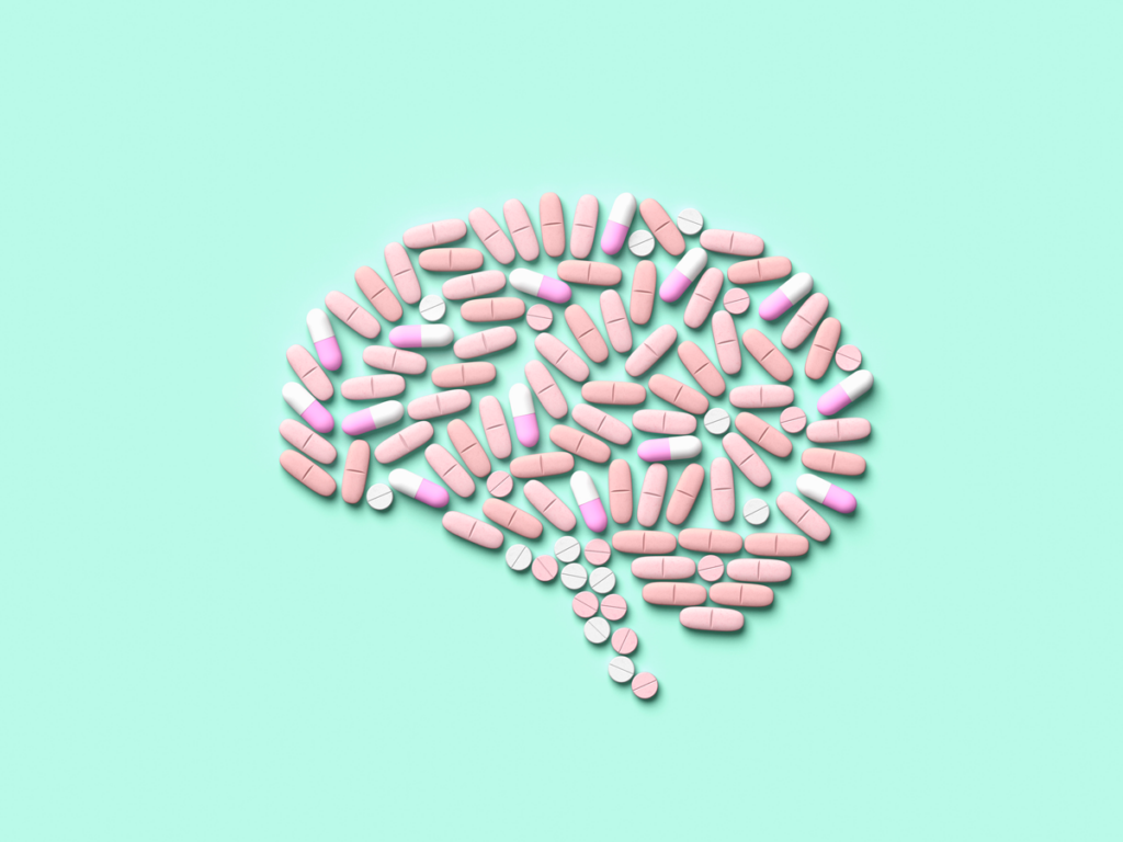 An illustration of a brain made of pills on a light blue background.