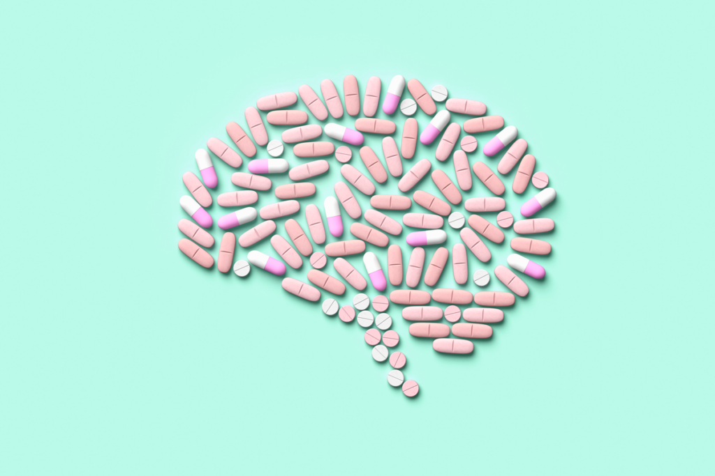 An illustration of a brain made of pills on a light blue background.