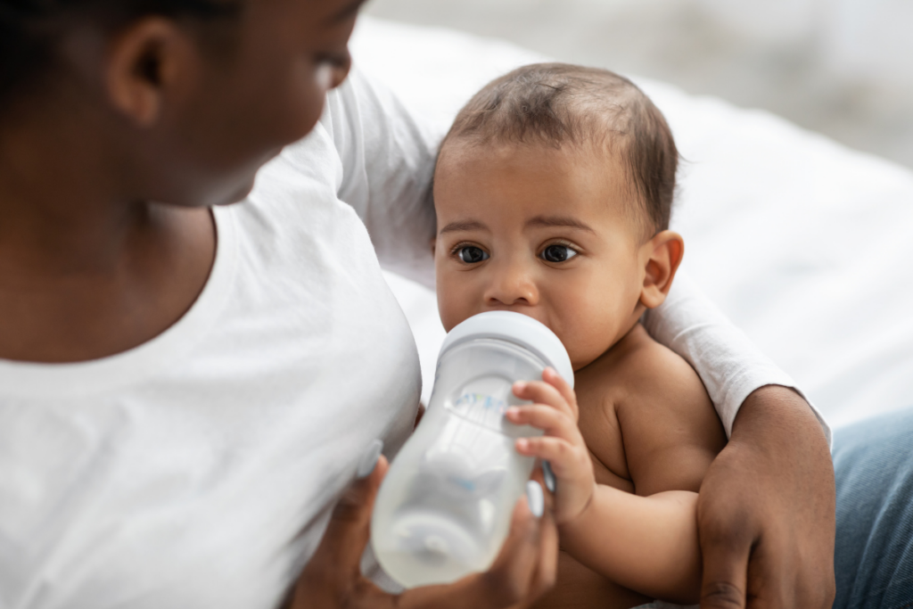 A baby drinking from a bottle.