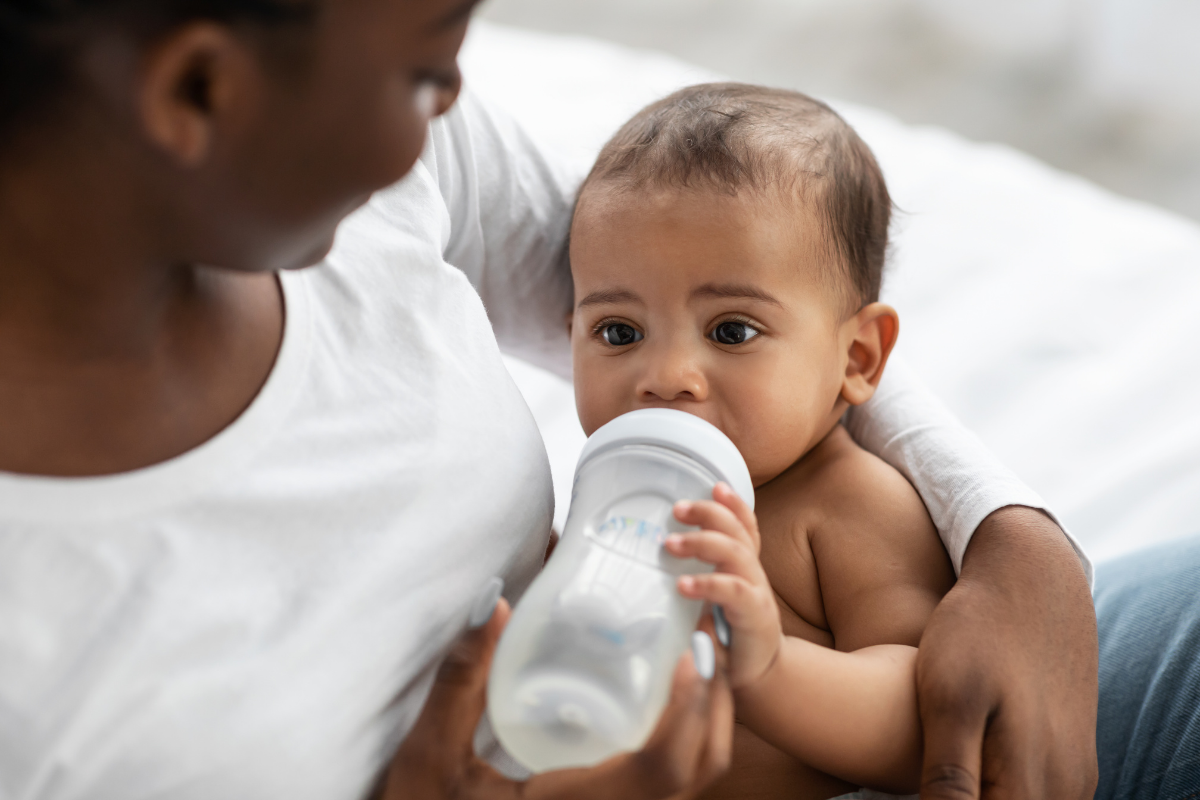 A baby drinking from a bottle.