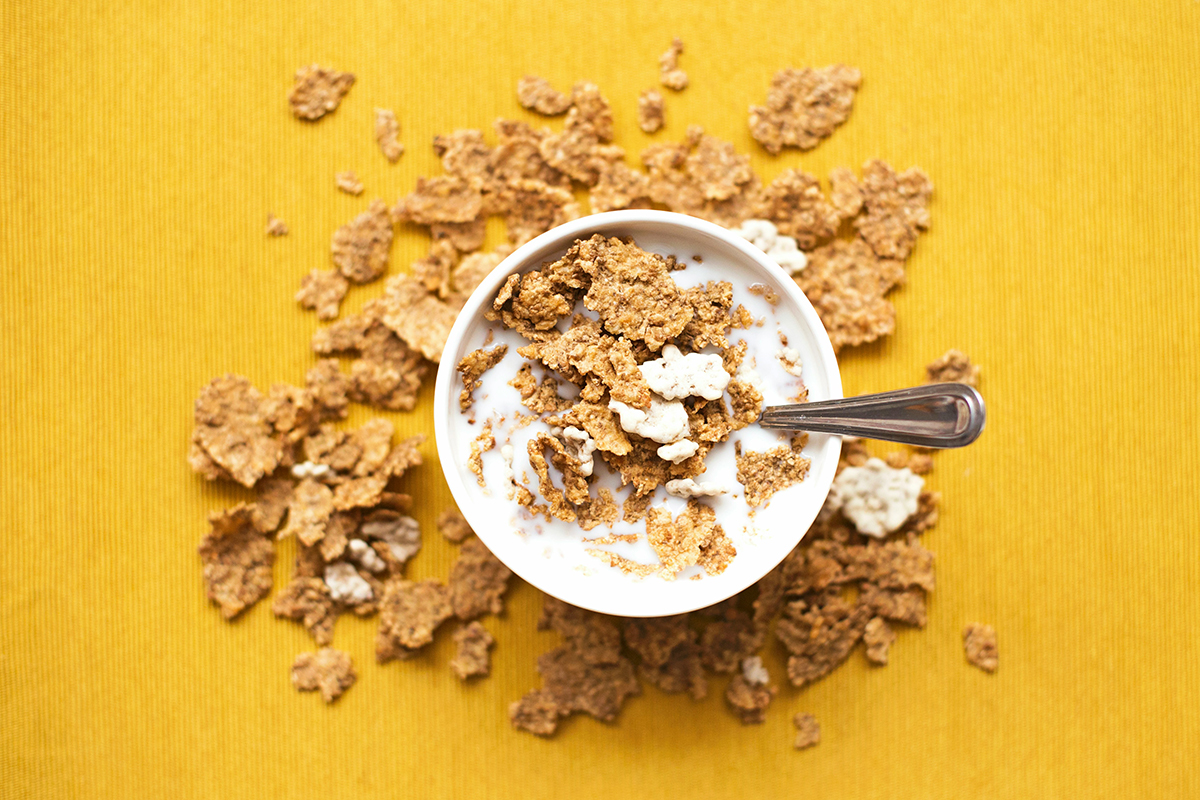 A bowl of cereal in a yellow background