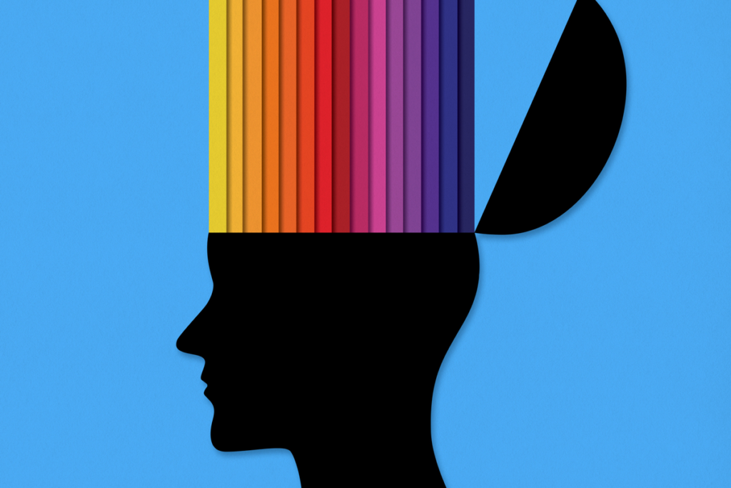 An illustration of a head, with the top opening up to reveal a rainbow of colors against a blue background.