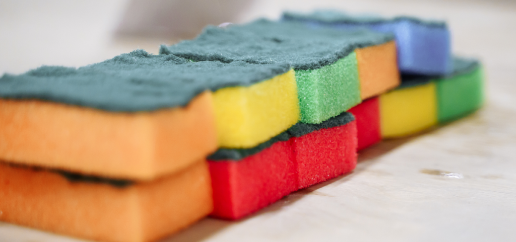 Close-up of several colorful kitchen sponges.