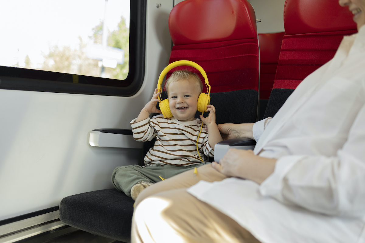 Mother and a baby listening to the music with headphones