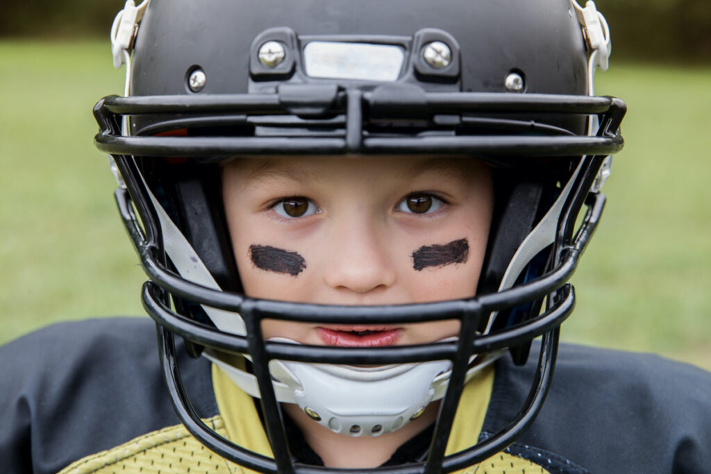 Kid wearing football helmet