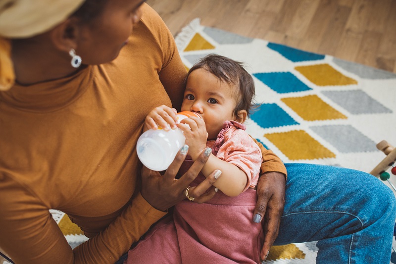 A woman bottle feeds a baby