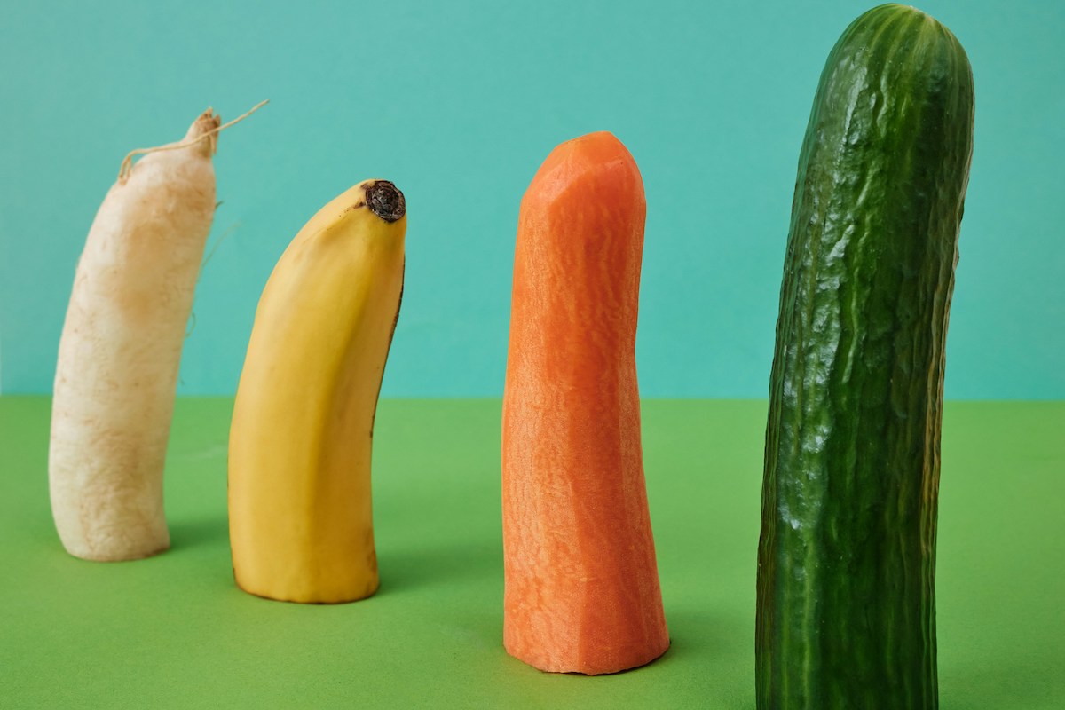 A group of phallic fruits and vegetables against a green and blue background illustrate "sex toys."