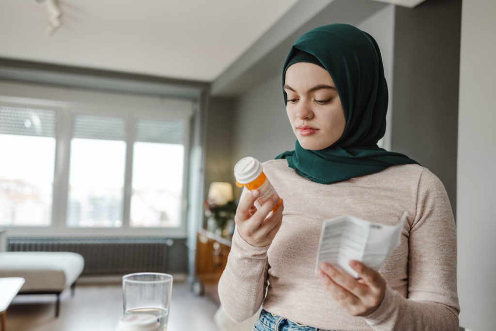 A person checking out medications.