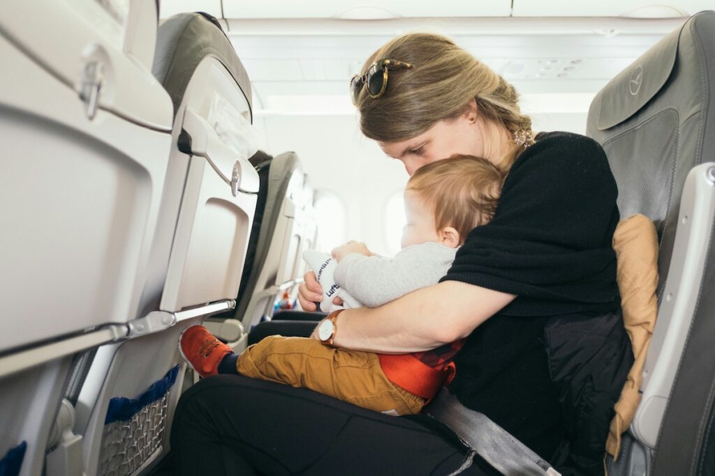 Baby on parent's lap on plane