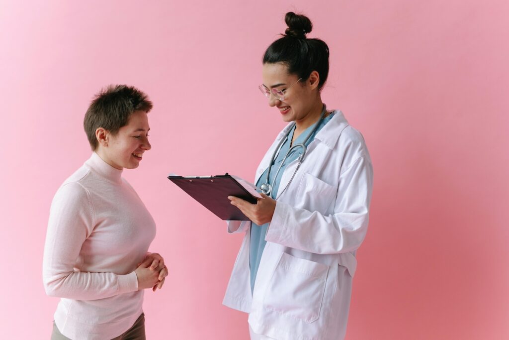 Doctor and patient on pink background
