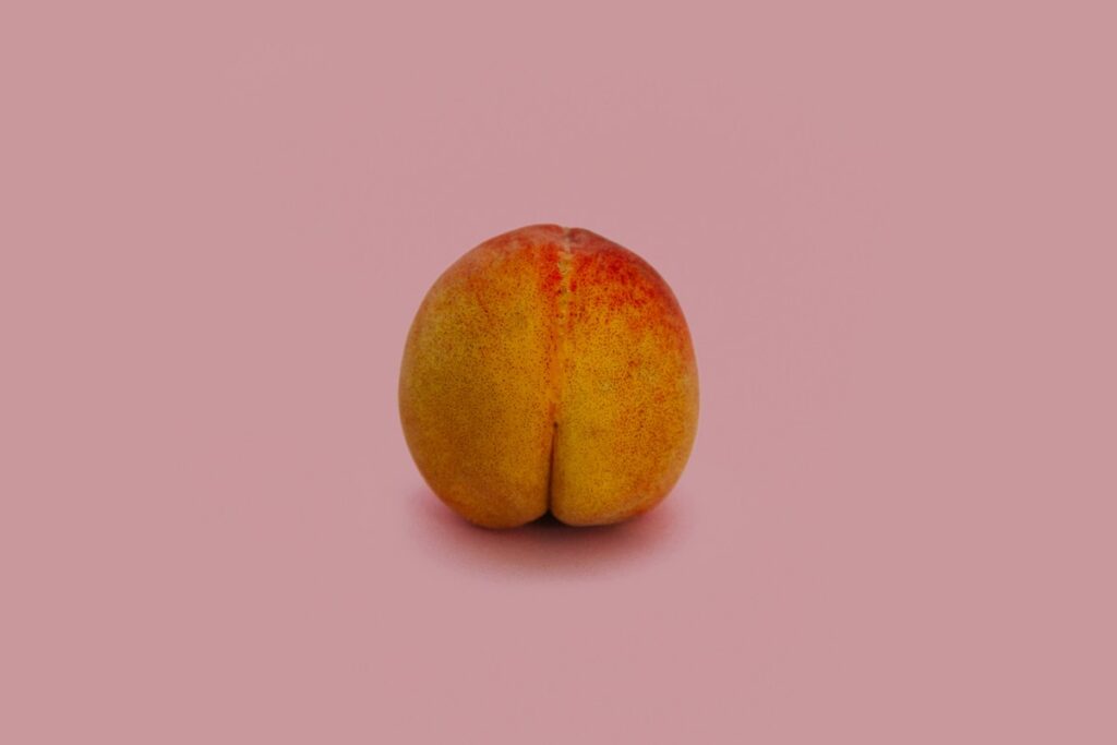 A ripe, butt-shaped peach.