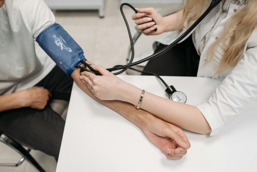 Doctor getting patient's blood pressure - view of their arms
