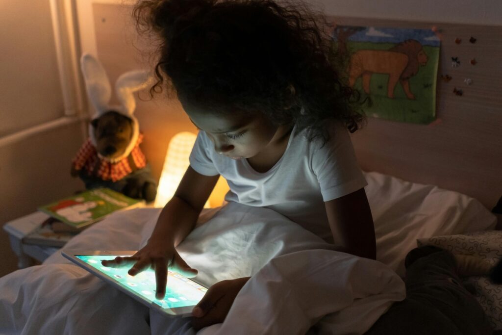 Child in bed with iPad