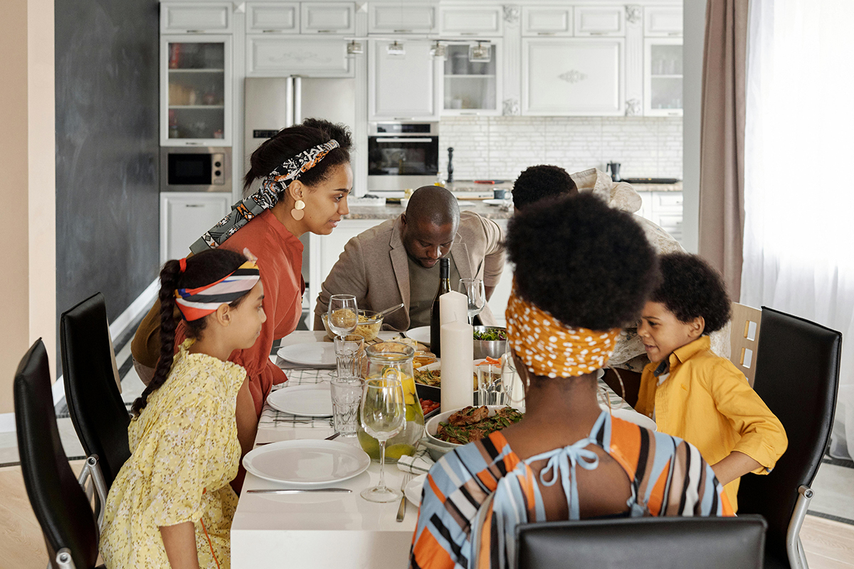 family sitting around a dining table for a dinner