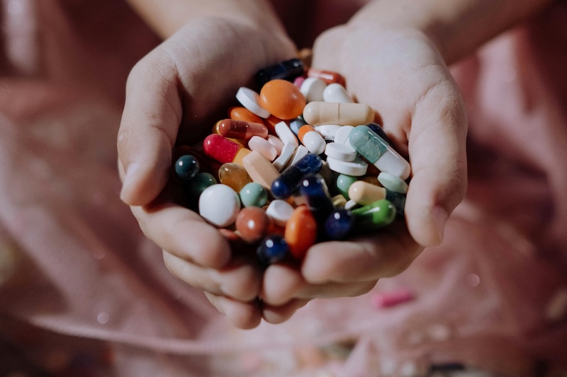 Tablets and capsules in cupped hands