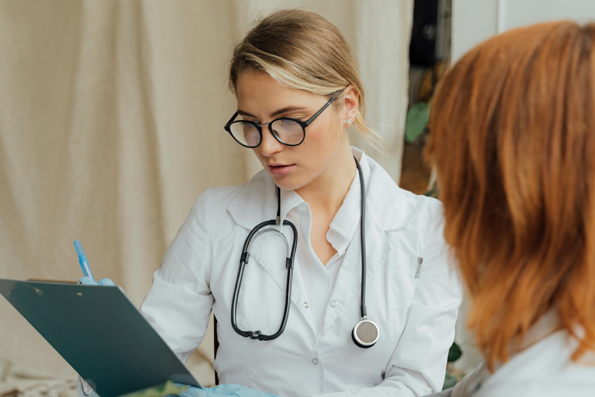 doctor checking report of a patient