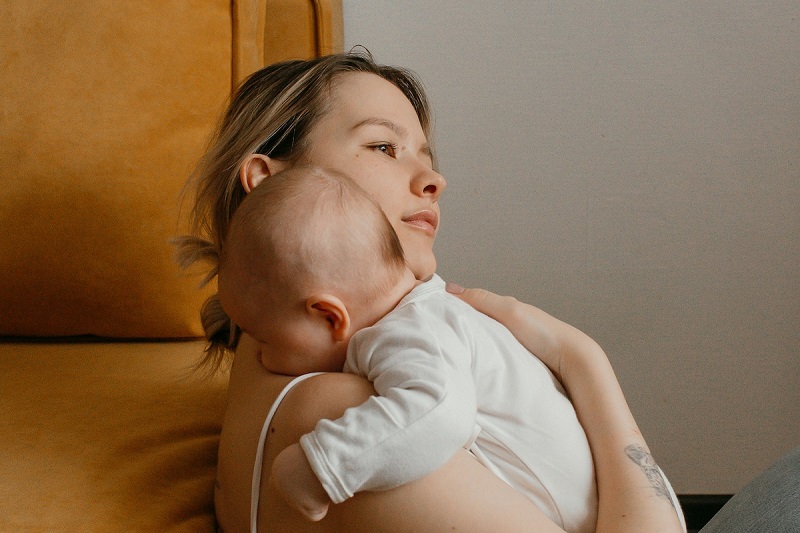 A parent holding a baby who is having hiccups