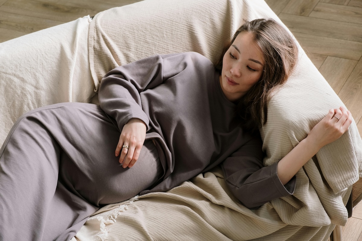 pregnant parent laying on couch