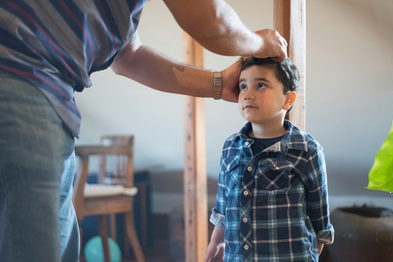 doctor measuring height of a kid