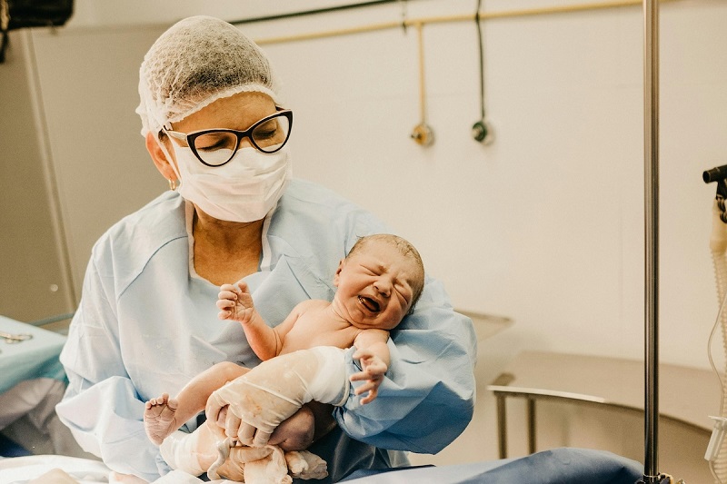 Nurse holding a new born baby