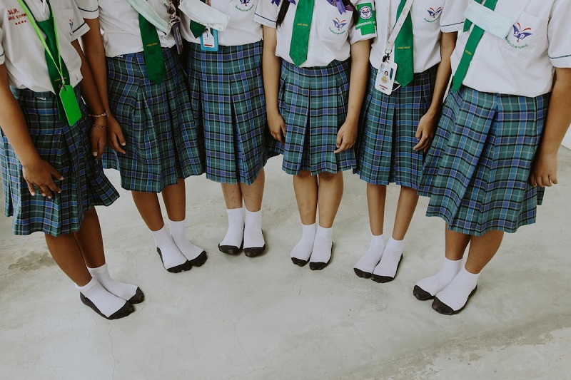 kids standing and wearing school uniforms