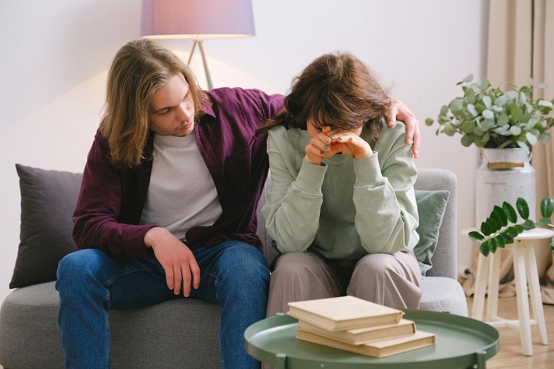 a couple sitting on a couch in a depressed moment